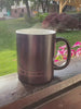 The mug changing from black to a street map as hot coffee is poured in